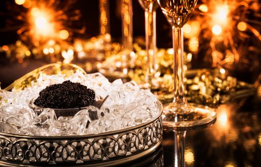 Caviar on ice with expensive wine glasses