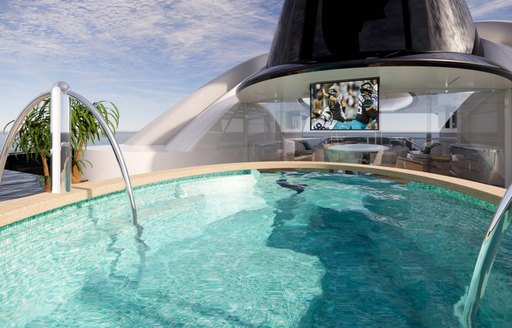 Overview of a swimming pool onboard charter yacht KISMET, with an outdoor cinema in the background