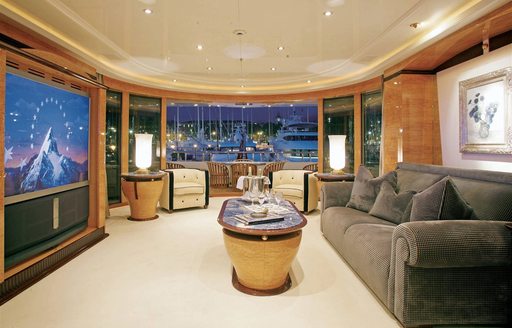 luxury motor yacht LADY LOLA master suite's salon with television and private deck area