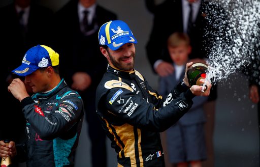 Formula E racer Jean-Eric Vergne spraying champagne and trophy ceremony