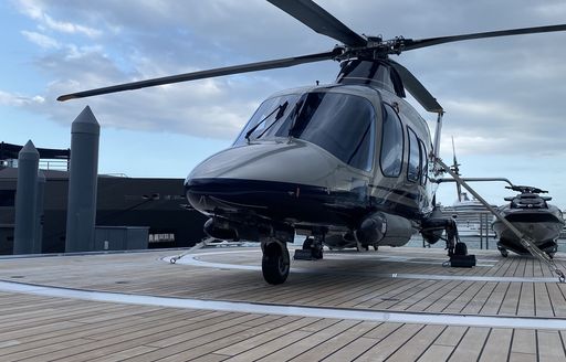 a sleek helicopter landing on superyacht BOLD 14 metre helipad at the miami yacht show 2020