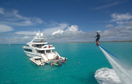 Charter guest plays with toys nearby superyacht Big Sky