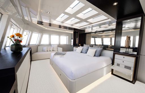 Master suite with large windows on board luxury yacht Enigma XK