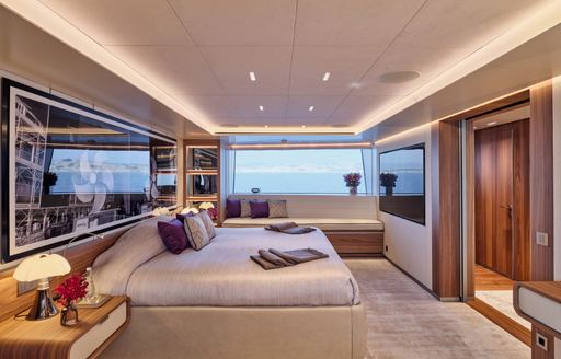Master cabin onboard charter yacht PARA BELLUM, central berth facing starboard with large window in the background