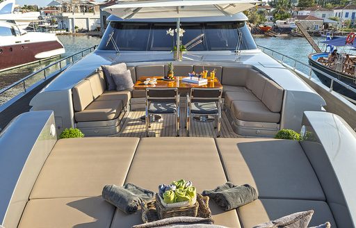 sun pads and casual alfresco dining area on bridge deck forward of luxury yacht ‘My Toy’ 
