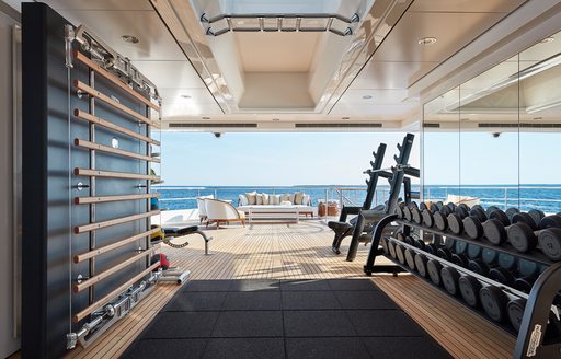 sun blaring into the well equipped and modern gym of luxury yacht JOY