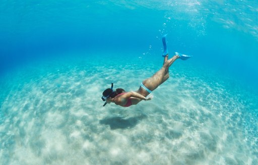 Charter guest snorkelling in the azure waters of Tahiti