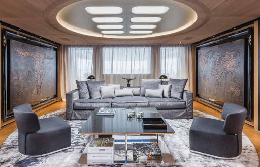 grey velvet sofa and skylight above in upper deck lounge on charter yacht SUERTE