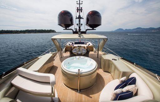 On-deck Jacuzzi onboard charter yacht YCM120, with plush seating and sweeping views of the sea