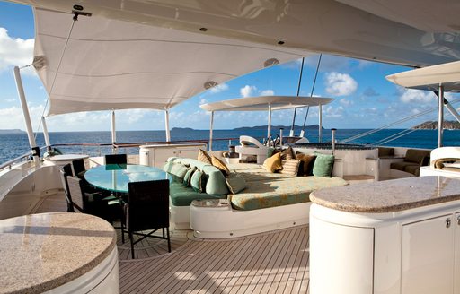 Fybridge with jacuzzi, sun pads, dining table of superyacht HEMISPHERE