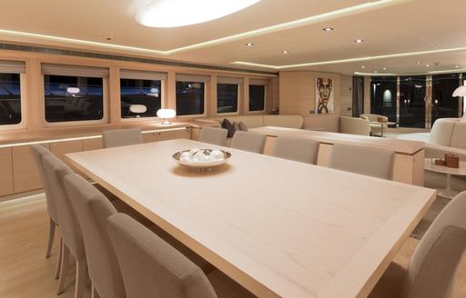 light wooden dining table in the main salon aboard motor yacht G3