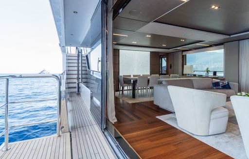 An open fold down balcony onboard charter yacht MInor Family Affair, with view of the main salon inside