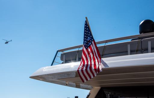Close up image of the US flag flying from the stern of a motor yacht.