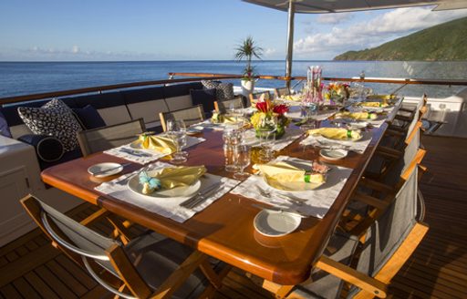 table set for alfresco dining on main deck aft of motor yacht TELEOST