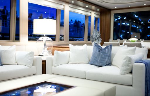 main salon on superyacht firefly, with blue artwork and white sofas