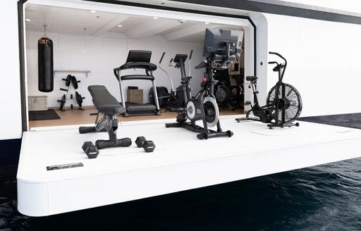 Gym area onboard charter yacht WAYFINDER, gym equipment on fold-down balcony