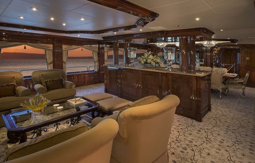 The formal furnishings and dark wood surroundings of superyacht Silver Lining