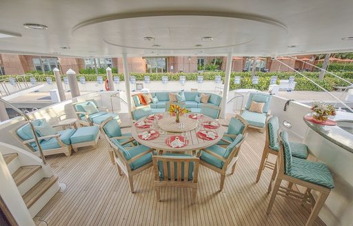 alfresco dining, bar and  lounging areas on main deck aft of charter yacht SERENGETI