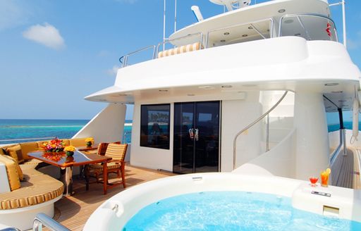 luxury motor yacht ARIOSO sundeck with jacuzzi and dining table for eating al fresco