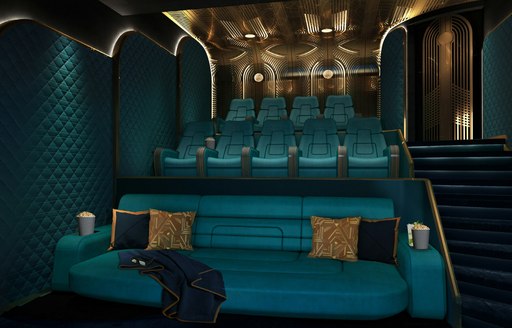 Interior cinema onboard charter yacht KISMET, plush teal seating and gold cushions