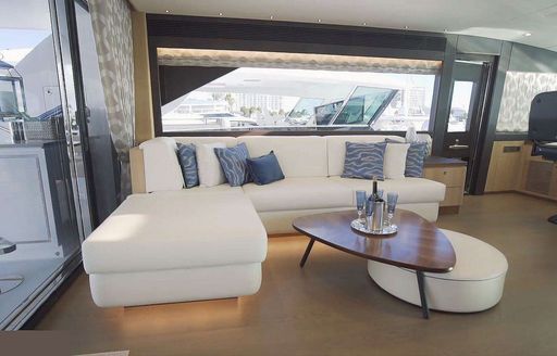 Comfortable sofa and table on motor yacht Aqua Life