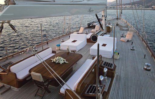 alfresco dining and sofas and sun loungers on foredeck of sailing yacht REGINA
