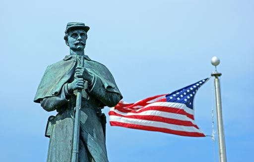 American Civil War statue in front of the American flag