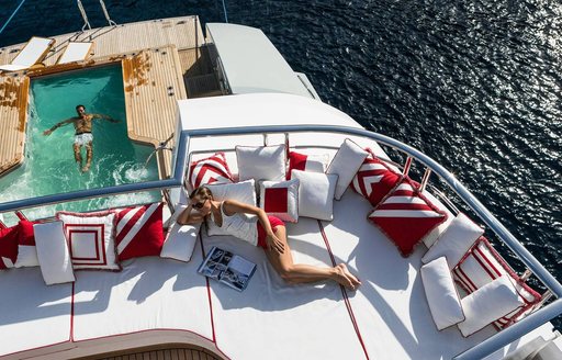 Woman reading on superyacht AXIOMA main deck