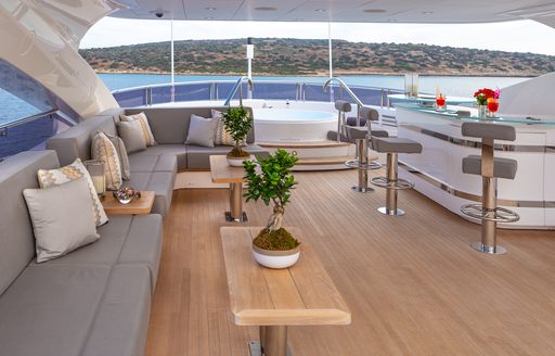 Overview of the sundeck onboard charter yacht AQUA LIBRA, alfresco seating area with a wet bar to starboard
