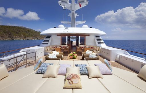Aft sun deck onboard charter yacht LADY BRITT, with sunpads in the foreground