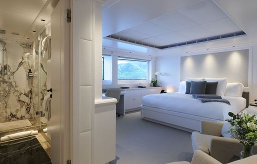 Master cabin onboard charter yacht ARBEMA, central berth with access to private en suite in the foreground