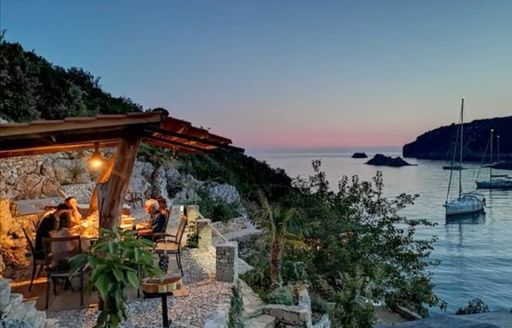 A stunning al fresco dining in the Lonely Planet restaurant on the island of Solta in Croatia, beautiful Tatinja bay