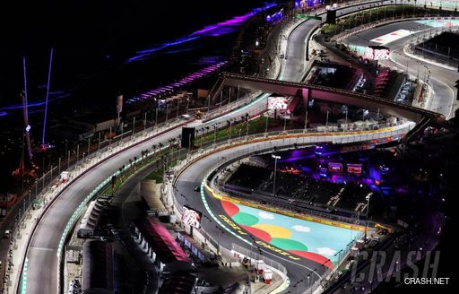 Overview of Jeddah Corniche Circuit at night, bends in the track visible, lit by floodlights.