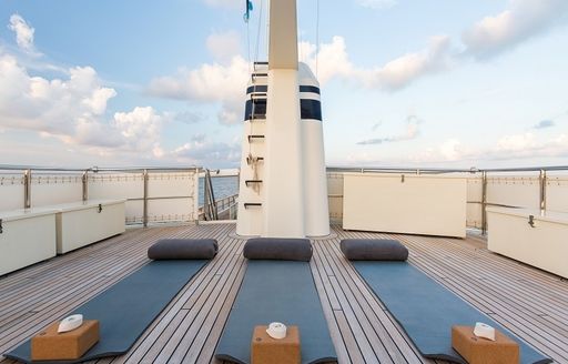 yoga mats line up on upper level of the sundeck on board luxury yacht PIONEER 