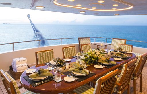 Luxury yacht dining set-up alfresco on main deck aft of At Last