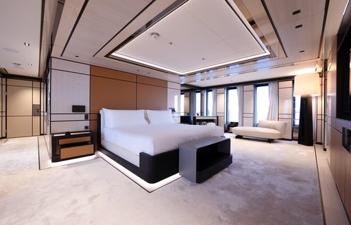 Overview of the master cabin onboard charter yacht RELIANCE, central berth with multiple windows in the background