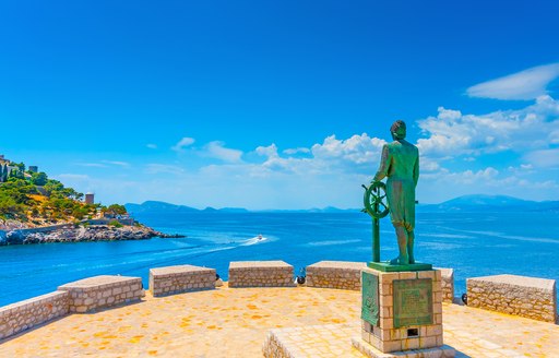 Statue of seaman overlooking Aegean Sea in Greece