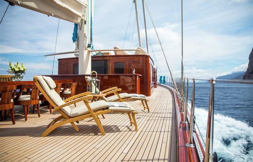sun loungers lined up alongside the alfresco dining table on board luxury yacht SATORI