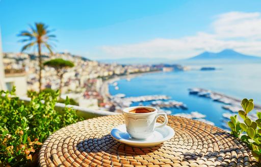 Coffee on a terrace in Naples overlooking the harbor, with Mount Vesuvius dominating the skyline in the distance