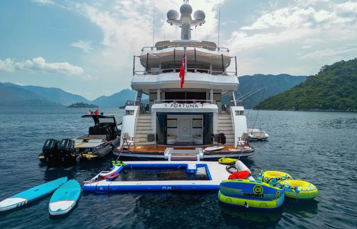 Aft view of charter yacht FORTUNA at anchor with a good selection of water toys adjacent