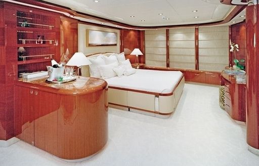full-beam master suite with lacquered wood panelling on board motor yacht ALLEGRIA 