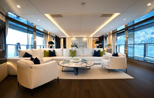 Main salon lounge onboard private yacht charter HALARA, with plush white seating
