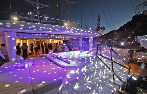 Sun deck of superyacht KATINA at night, with party lights over Jacuzzi
