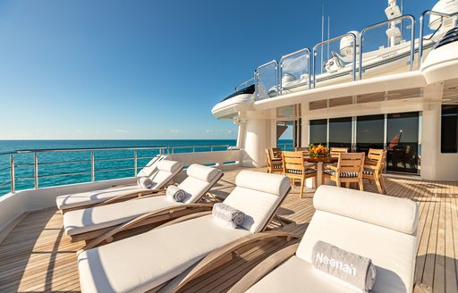 Upper deck sun loungers on board charter yacht NEENAH