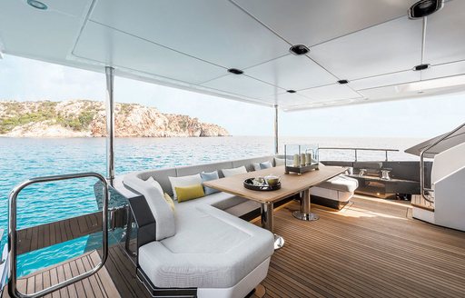 Exterior deck onboard charter yacht VESTA, with alfresco dining option overlooking the sea