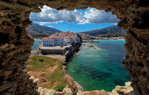 looking out onto Greek town from a cave