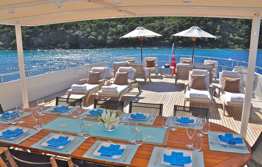 alfresco dining and chaise loungers on upper deck aft of motor yacht LIONSHARE 