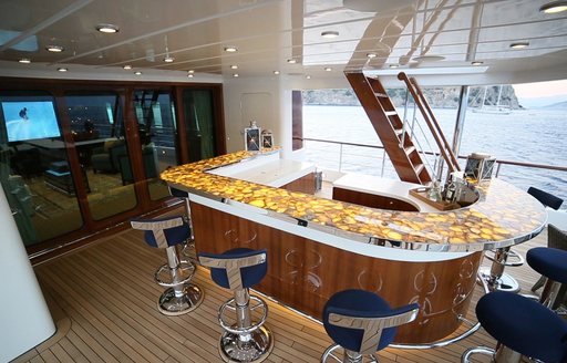 agate-topped bar with navy blue stools on the upper deck aft of motor yacht CLARITY  