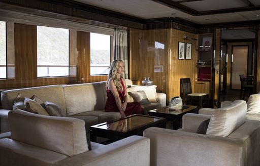 charter guests sits in main salon on board motor yacht MEAMINA 