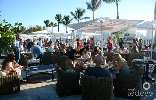 guests sit in Cabana lounges at The Deck, Island Gardens in Miami